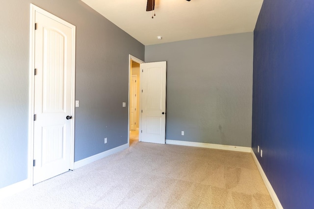 empty room with ceiling fan and carpet