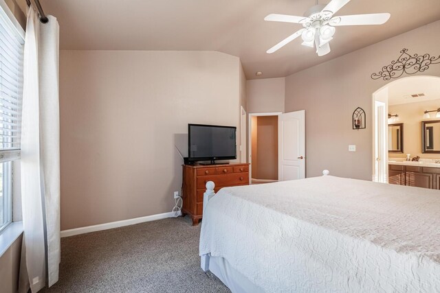 bedroom featuring arched walkways, carpet floors, visible vents, baseboards, and vaulted ceiling