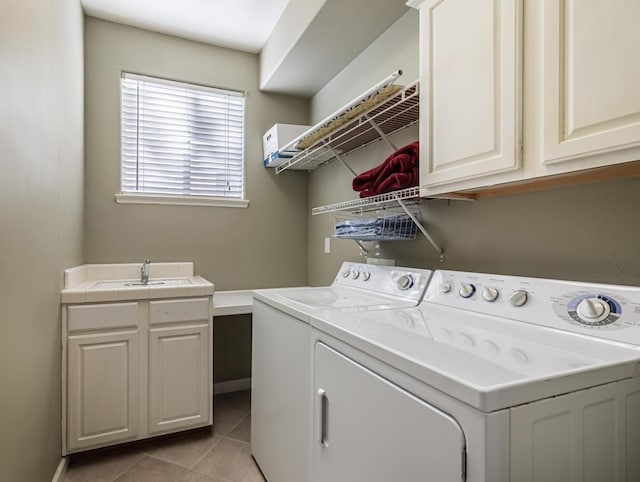 laundry area with light tile patterned flooring, independent washer and dryer, a sink, and cabinet space