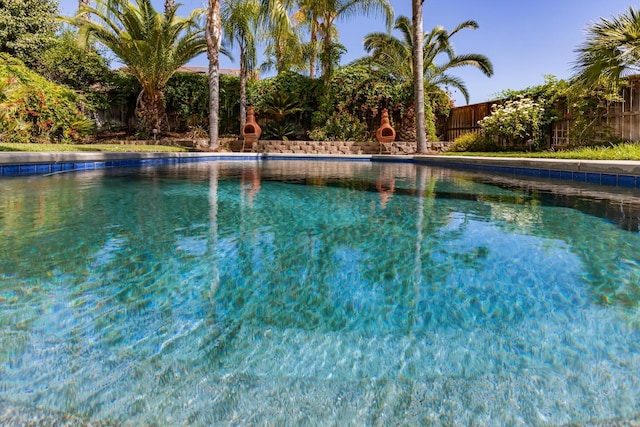 view of swimming pool with fence and a fenced in pool