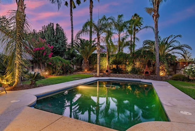 outdoor pool with a fenced backyard