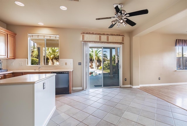 kitchen featuring light tile patterned floors, light countertops, dishwasher, tasteful backsplash, and plenty of natural light