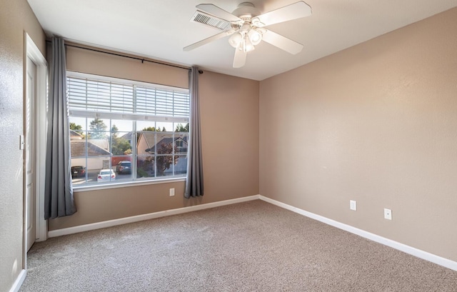 unfurnished room featuring a ceiling fan, carpet flooring, visible vents, and baseboards