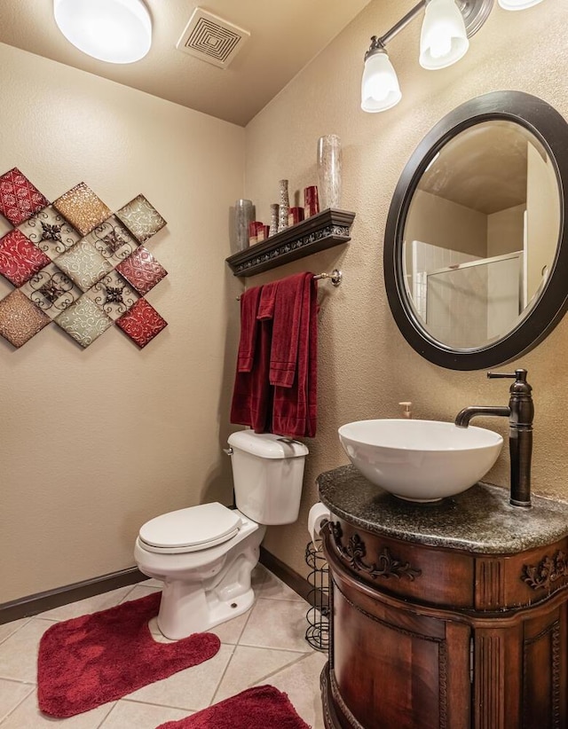 bathroom featuring visible vents, a shower, baseboards, toilet, and tile patterned flooring