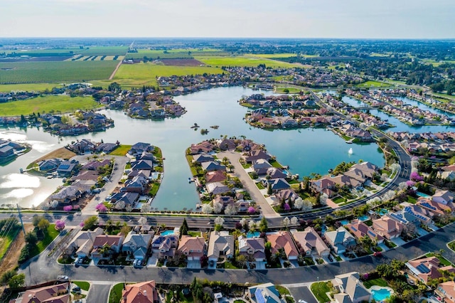 birds eye view of property with a water view and a residential view