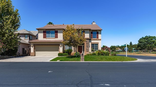 view of front of house with driveway, stucco siding, a chimney, an attached garage, and a front yard