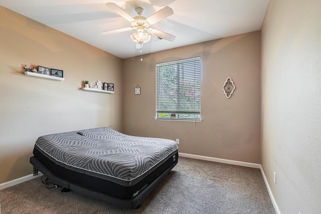 carpeted bedroom with a ceiling fan and baseboards