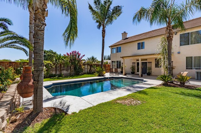 view of swimming pool featuring a patio area, a fenced backyard, a fenced in pool, and a yard