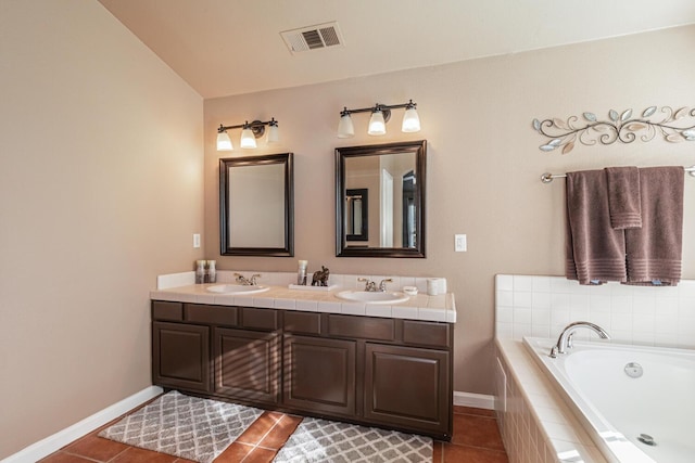 bathroom featuring a garden tub, tile patterned flooring, a sink, and visible vents