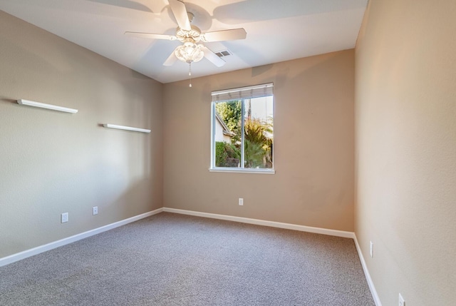 unfurnished room with carpet floors, visible vents, ceiling fan, and baseboards