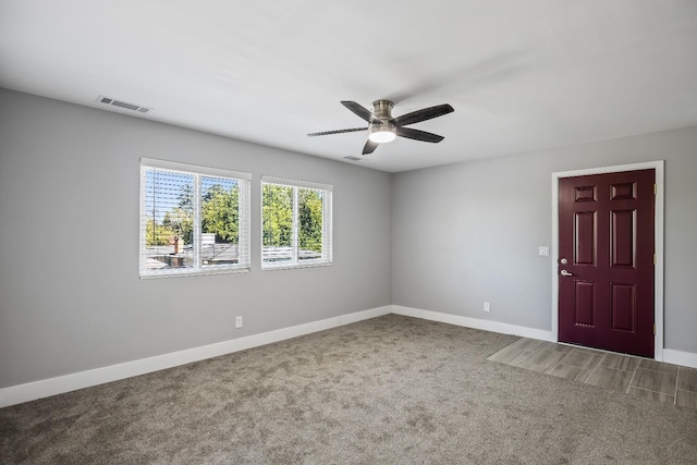 interior space with ceiling fan and carpet flooring