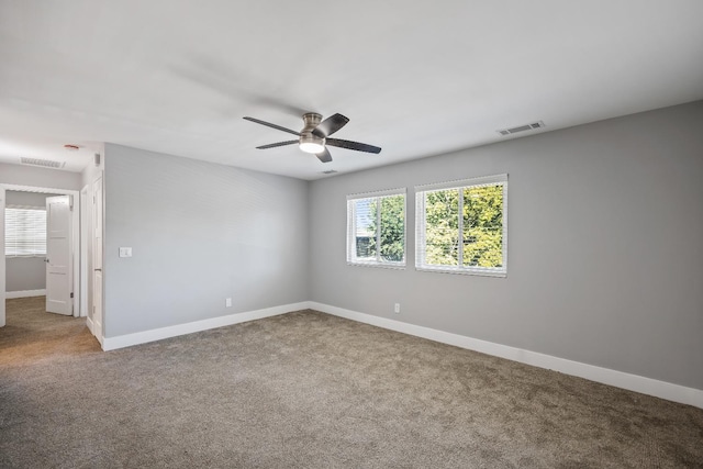 carpeted spare room featuring ceiling fan