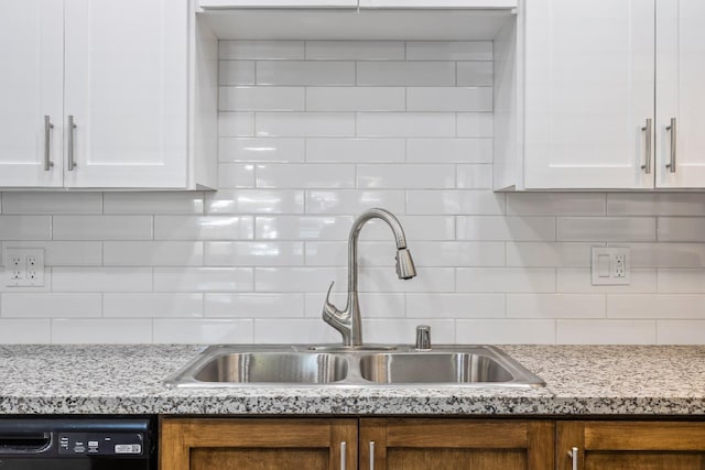 kitchen with backsplash, sink, dishwasher, and white cabinets