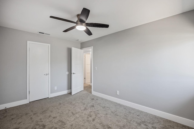 unfurnished bedroom featuring ceiling fan and light carpet