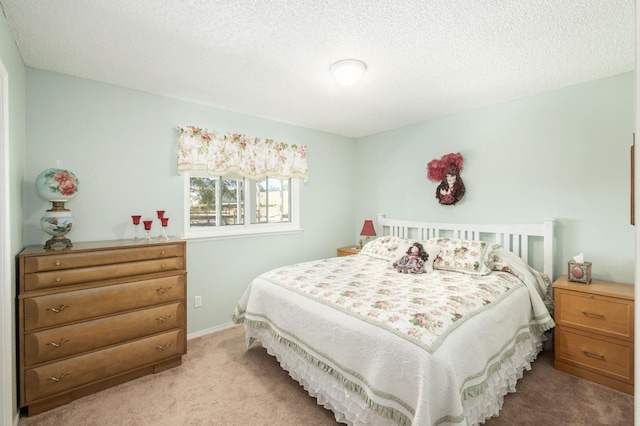 bedroom with baseboards, a textured ceiling, and light colored carpet