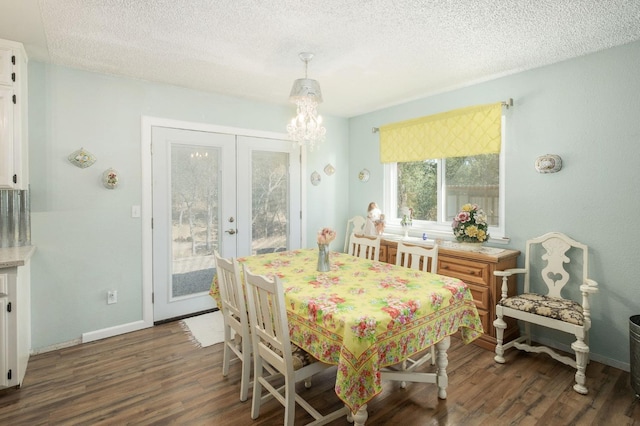 dining room with a textured ceiling, a chandelier, wood finished floors, baseboards, and french doors