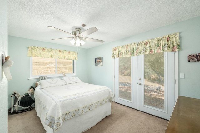 bedroom with a textured ceiling, ceiling fan, carpet floors, and access to exterior