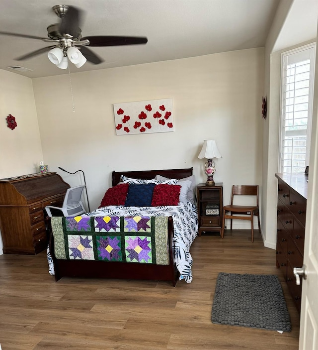 bedroom with hardwood / wood-style floors and ceiling fan