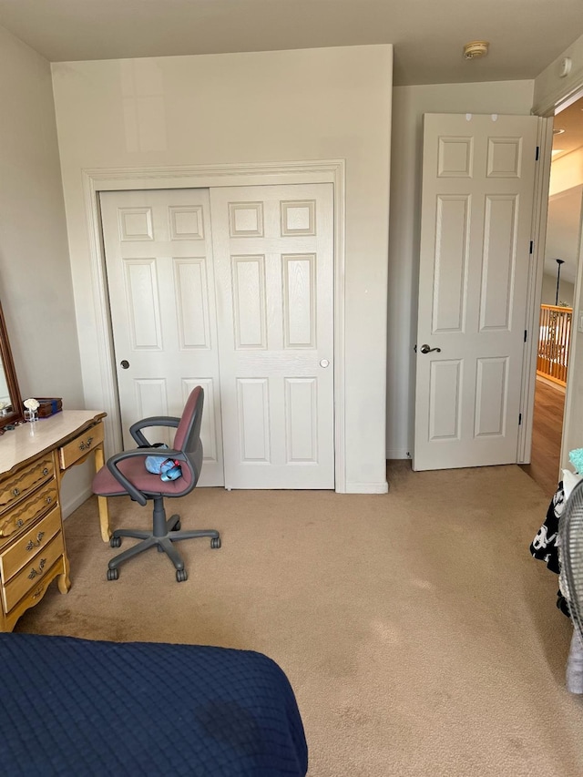 bedroom with light carpet and a closet