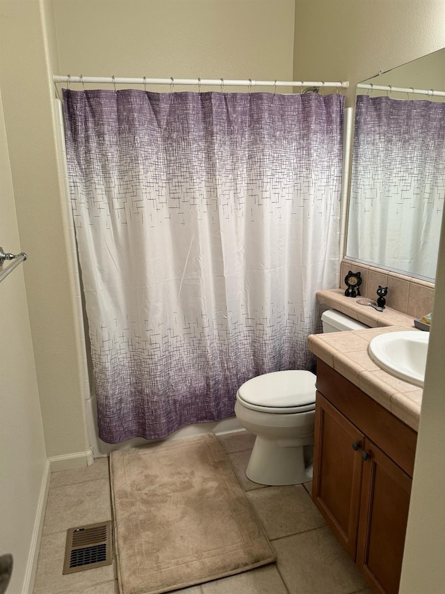 bathroom featuring toilet, tile patterned flooring, and vanity