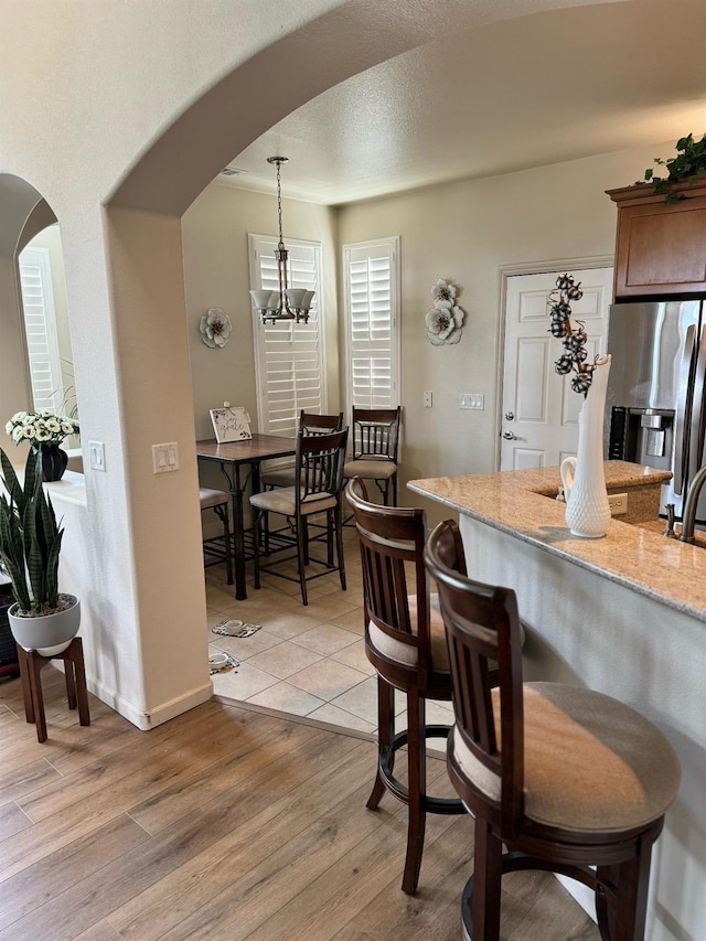 dining room featuring a notable chandelier and light hardwood / wood-style floors