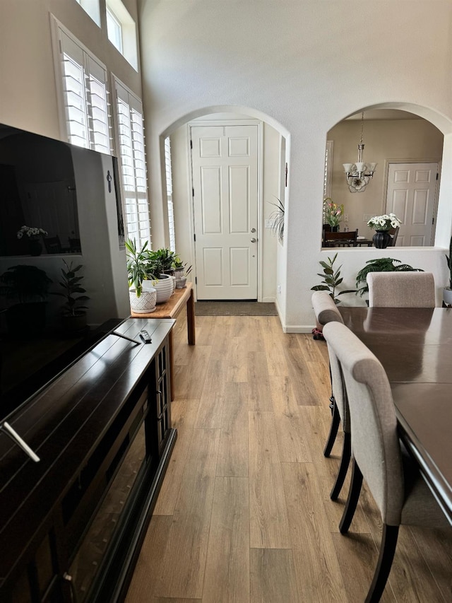 entryway featuring an inviting chandelier and light wood-type flooring