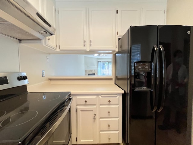 kitchen featuring electric range, white cabinets, light countertops, black fridge, and exhaust hood