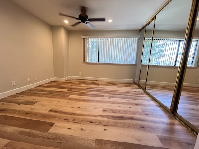 empty room with recessed lighting, baseboards, and light wood finished floors