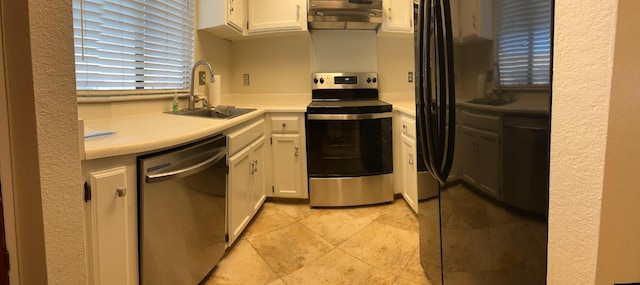 kitchen featuring light countertops, appliances with stainless steel finishes, a sink, and white cabinets