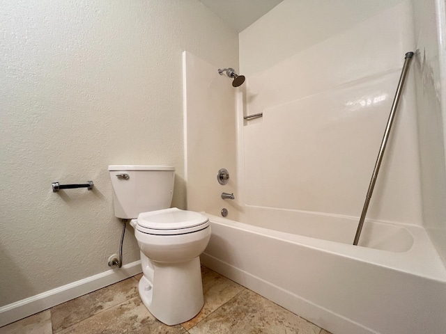 full bathroom featuring a textured wall,  shower combination, toilet, and baseboards