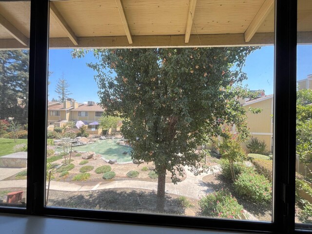 exterior space featuring wood ceiling and beamed ceiling