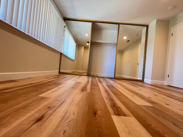 interior space featuring light wood-style floors and baseboards