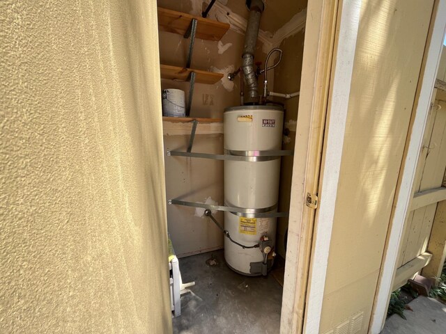 utility room featuring strapped water heater