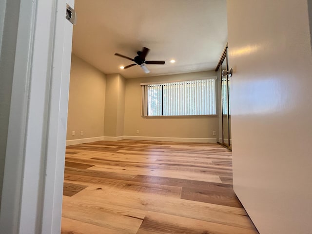 spare room with baseboards, recessed lighting, light wood-style flooring, and a ceiling fan