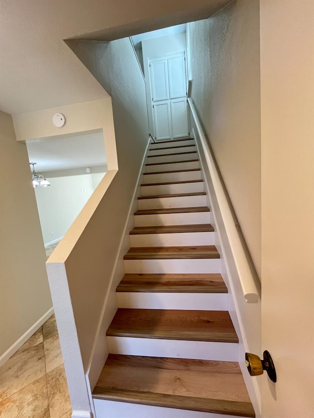 stairway with tile patterned flooring