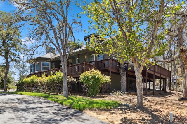 view of side of property with a wooden deck