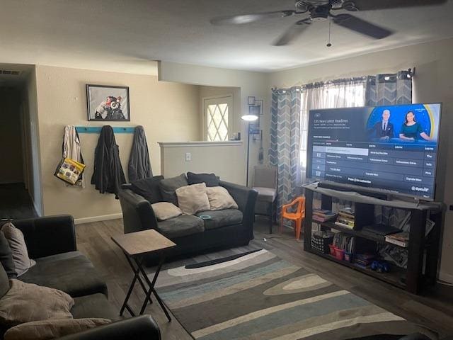 living room featuring hardwood / wood-style floors and ceiling fan