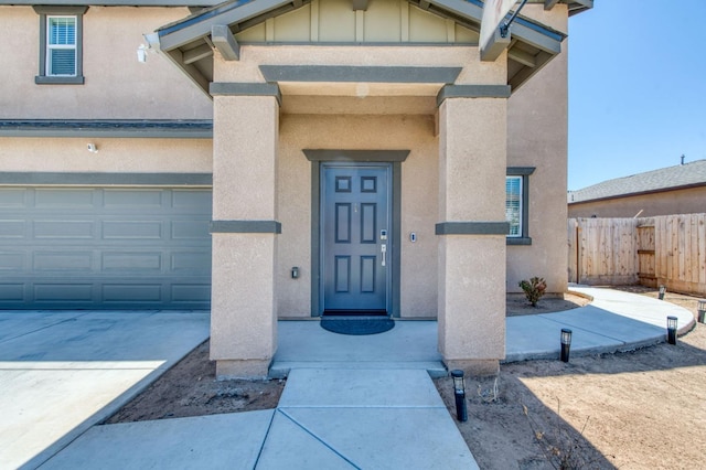 doorway to property with a garage