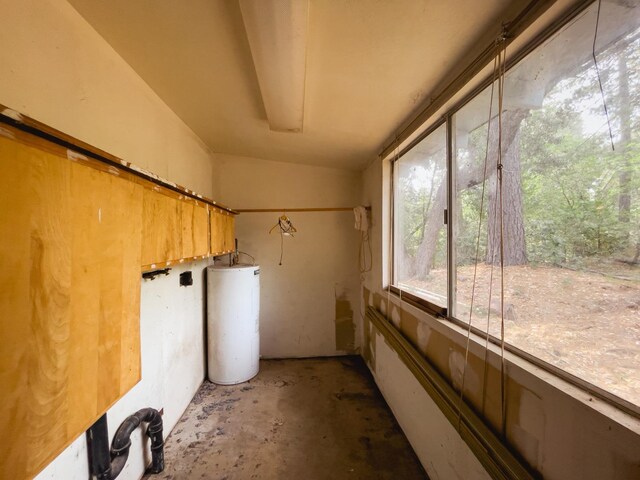 unfurnished sunroom with vaulted ceiling and water heater