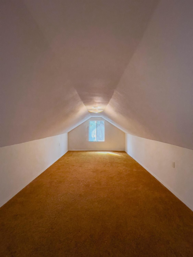 bonus room with carpet floors and lofted ceiling