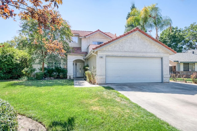 mediterranean / spanish house with a front lawn and a garage