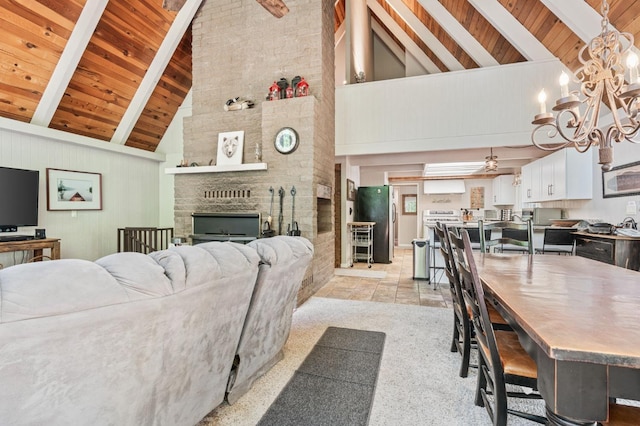 carpeted living room featuring beam ceiling, brick wall, high vaulted ceiling, wood ceiling, and a brick fireplace