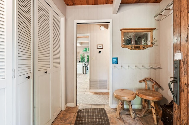 interior space with light tile patterned flooring and wooden ceiling