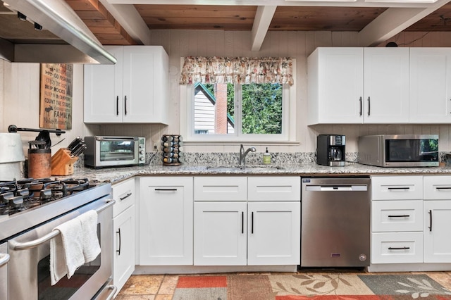 kitchen featuring appliances with stainless steel finishes, wall chimney exhaust hood, wooden ceiling, and beamed ceiling