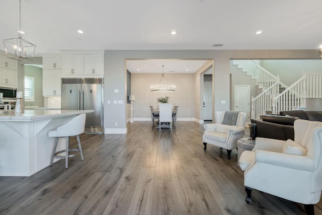 living room featuring hardwood / wood-style floors and an inviting chandelier