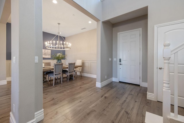 entrance foyer featuring hardwood / wood-style flooring and a notable chandelier