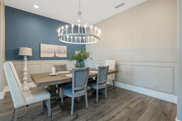 dining room featuring dark wood-type flooring and a notable chandelier