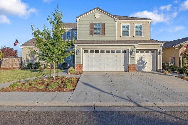 front facade featuring a garage and a front lawn