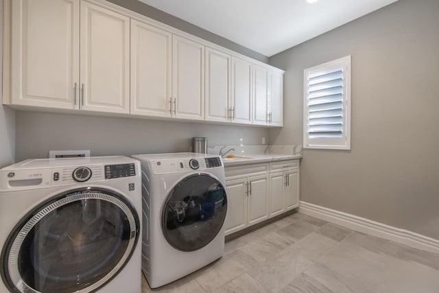 laundry room with cabinets, sink, and independent washer and dryer