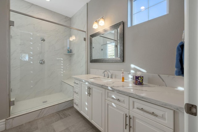 bathroom with vanity, a wealth of natural light, and walk in shower